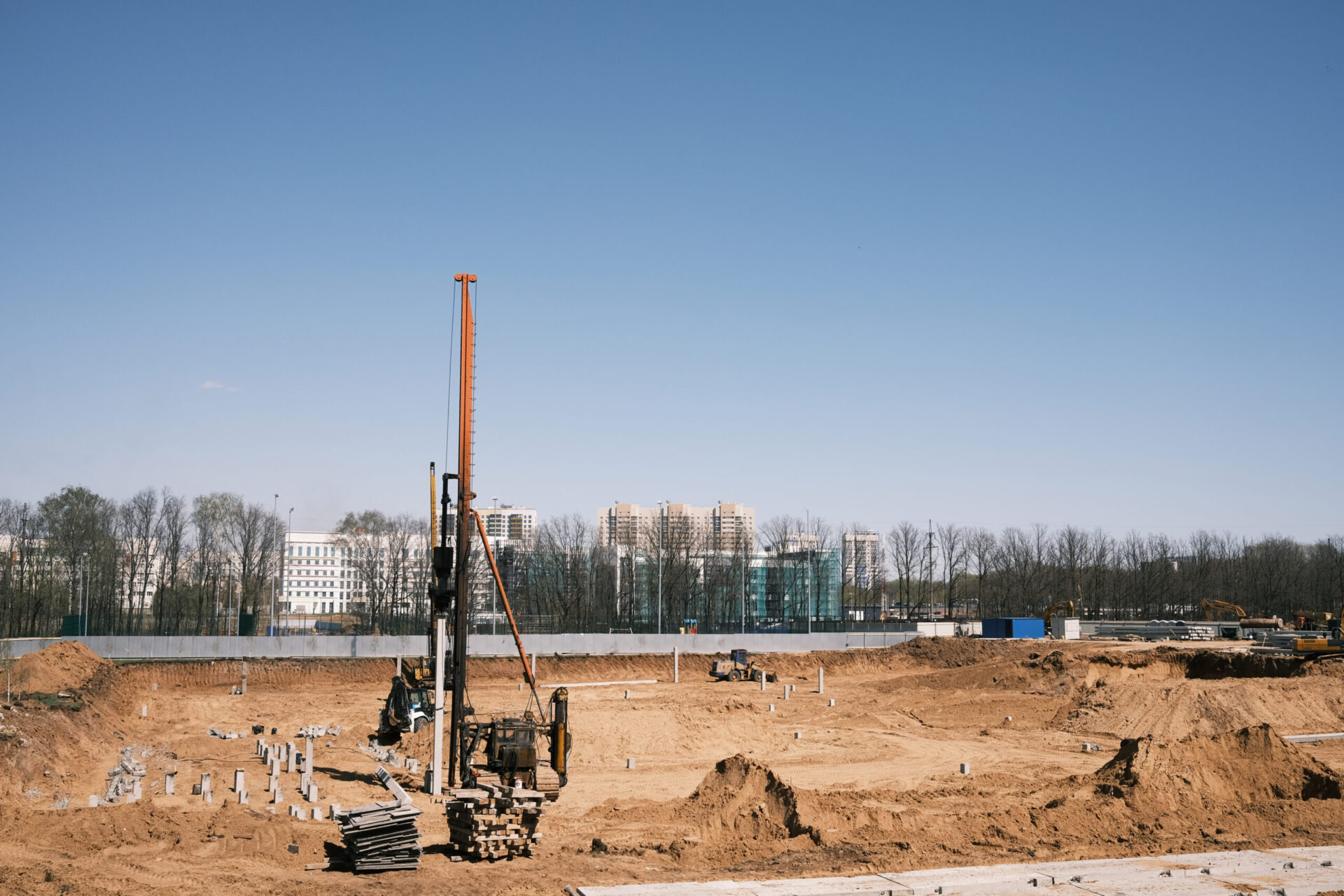 Driving and forming the pile foundation. Pile driven into ground by vibrating hydraulic hammer. Foundations construction work.Drill bore pile rig machine at the construction site.